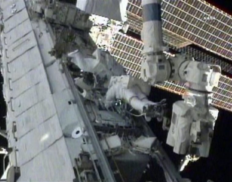 In this photo taken from NASA television, Expedition 24 astronauts work outside the space station, Monday, Aug. 16, 2010. 
